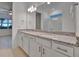 Double vanity bathroom with granite countertop and modern fixtures at 10426 Abaco Falls Dr, Englewood, FL 34223