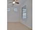 Simple bedroom with neutral walls, ceiling fan and window blinds at 10426 Abaco Falls Dr, Englewood, FL 34223