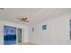 Bedroom with sliding glass doors leading to a pool and lanai at 10426 Abaco Falls Dr, Englewood, FL 34223