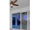 Bedroom with sliding glass doors and a ceiling fan at 10426 Abaco Falls Dr, Englewood, FL 34223