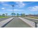 Outdoor bocce ball courts with shade structures, lush landscaping, and blue skies at 10426 Abaco Falls Dr, Englewood, FL 34223