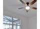 Bright bedroom with a ceiling fan and large window at 10426 Abaco Falls Dr, Englewood, FL 34223