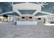 Bright clubhouse interior with open space, modern decor, a bar with backsplash, and high ceilings at 10426 Abaco Falls Dr, Englewood, FL 34223