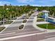Aerial view of Beachwalk community entrance with palm trees and landscaped medians at 10426 Abaco Falls Dr, Englewood, FL 34223