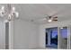 Dining room with sliding glass doors, chandelier, and ceiling fan at 10426 Abaco Falls Dr, Englewood, FL 34223