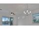 Bright dining room with chandelier and sliding glass doors to patio at 10426 Abaco Falls Dr, Englewood, FL 34223