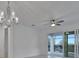 Spacious dining room with ceiling fan and sliding glass doors at 10426 Abaco Falls Dr, Englewood, FL 34223