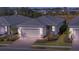 Single-story home with gray tile roof and attached garage, beautifully landscaped at 10426 Abaco Falls Dr, Englewood, FL 34223
