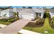 Single-story home with gray tile roof, attached garage, and landscaped front yard at 10426 Abaco Falls Dr, Englewood, FL 34223