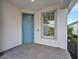 Front porch with light blue door, perfect for relaxing at 10426 Abaco Falls Dr, Englewood, FL 34223