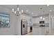 Open concept kitchen with island and stainless steel appliances at 10426 Abaco Falls Dr, Englewood, FL 34223