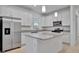 Spacious kitchen with island, stainless steel appliances, and granite countertops at 10426 Abaco Falls Dr, Englewood, FL 34223