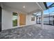 This covered patio features sliding glass doors leading inside at 10426 Abaco Falls Dr, Englewood, FL 34223
