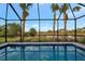 Enjoy the tranquil view from this screened-in pool area at 10426 Abaco Falls Dr, Englewood, FL 34223