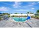 Relaxing outdoor pool with seating, well-maintained landscaping, and a tranquil atmosphere at 10426 Abaco Falls Dr, Englewood, FL 34223