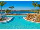 Relaxing pool at Beachwalk with waterfall feature and lake view at 10426 Abaco Falls Dr, Englewood, FL 34223
