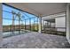 Covered patio with screened pool and view of the surrounding landscape at 10426 Abaco Falls Dr, Englewood, FL 34223