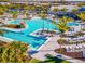 Beachwalk resort-style pool with expansive deck, lap lanes, and waterfall feature at 10426 Abaco Falls Dr, Englewood, FL 34223