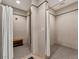 Clean showers with individual curtains and bench at 10426 Abaco Falls Dr, Englewood, FL 34223