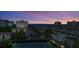 Aerial view of community at sunset with tennis courts and ocean view at 1200 E Peppertree Ln # 307, Sarasota, FL 34242