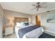 Comfortable bedroom featuring coastal decor, a wood headboard, and access to the bathroom at 1200 E Peppertree Ln # 307, Sarasota, FL 34242