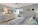 Well-lit bedroom with blue accents, comfortable bed and a decorative fish on the wall at 1200 E Peppertree Ln # 307, Sarasota, FL 34242