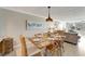 Charming dining area with a wood table, beach-themed decor, and ample natural light at 1200 E Peppertree Ln # 307, Sarasota, FL 34242