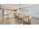 Inviting dining room with a rustic table, coastal decor, and open flow to the kitchen at 1200 E Peppertree Ln # 307, Sarasota, FL 34242