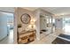 Condo entry with a console table, mirror and wicker baskets at 1200 E Peppertree Ln # 307, Sarasota, FL 34242