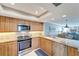 Modern kitchen with stainless steel appliances and wood cabinets at 1200 E Peppertree Ln # 307, Sarasota, FL 34242