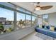 Cozy sunroom with bright windows, comfortable seating, and a view of the tennis courts and city at 1200 E Peppertree Ln # 307, Sarasota, FL 34242