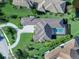 Luxury home with pool and circular driveway, as seen from above at 19405 Ganton Ave, Lakewood Ranch, FL 34202