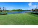 Peaceful backyard setting with lush grass and lake view at 19405 Ganton Ave, Lakewood Ranch, FL 34202