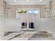 Spa-like bathroom with double shower heads and pebble floor at 19405 Ganton Ave, Lakewood Ranch, FL 34202