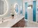 Bathroom with double sinks, frameless mirrors and shower at 19405 Ganton Ave, Lakewood Ranch, FL 34202