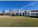 White clubhouse with red tile roof and a large lawn at 19405 Ganton Ave, Lakewood Ranch, FL 34202
