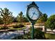 Large green clock in a landscaped area of a community at 19405 Ganton Ave, Lakewood Ranch, FL 34202