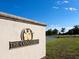 Entrance to a community with a stone wall and logo at 19405 Ganton Ave, Lakewood Ranch, FL 34202