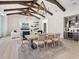 Elegant dining room with modern table and chairs, adjacent to living room and bar at 19405 Ganton Ave, Lakewood Ranch, FL 34202