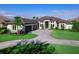 Luxury home with three-car garage, paver driveway, and lush landscaping at 19405 Ganton Ave, Lakewood Ranch, FL 34202