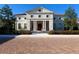 Grand home with columns, a tile roof, and manicured landscaping at 19405 Ganton Ave, Lakewood Ranch, FL 34202
