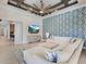 Spacious Gathering room with sectional sofa and blue patterned accent wall at 19405 Ganton Ave, Lakewood Ranch, FL 34202