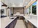 Gourmet kitchen with island, stainless steel appliances, and white quartz countertops at 19405 Ganton Ave, Lakewood Ranch, FL 34202
