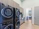 Bright laundry room, featuring modern washer and dryer, and built-in cabinetry at 19405 Ganton Ave, Lakewood Ranch, FL 34202