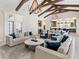 Open living room with high ceilings, exposed beams, and comfortable seating at 19405 Ganton Ave, Lakewood Ranch, FL 34202