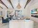 Spacious living area with exposed beams, fireplace, and access to pool at 19405 Ganton Ave, Lakewood Ranch, FL 34202