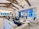 Open living area with high ceilings, exposed beams, and elegant chandelier at 19405 Ganton Ave, Lakewood Ranch, FL 34202