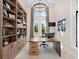 Home office with built-in shelves, large desk, and natural light at 19405 Ganton Ave, Lakewood Ranch, FL 34202