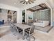 Spacious covered patio with dining table and seating, offering views to the living room at 19405 Ganton Ave, Lakewood Ranch, FL 34202