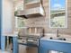 Stainless steel grill, sink, and granite countertop in this outdoor kitchen at 19405 Ganton Ave, Lakewood Ranch, FL 34202